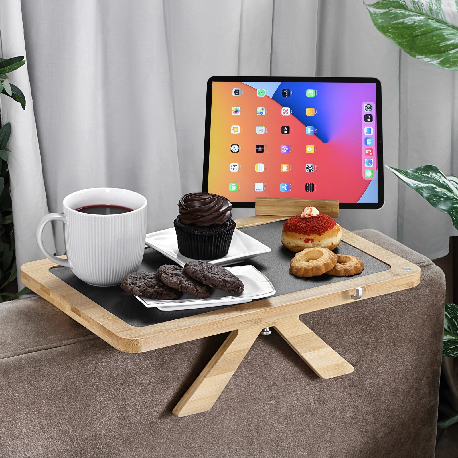 Bamboo arm tray holding a tablet, coffee, and dessert on a sofa