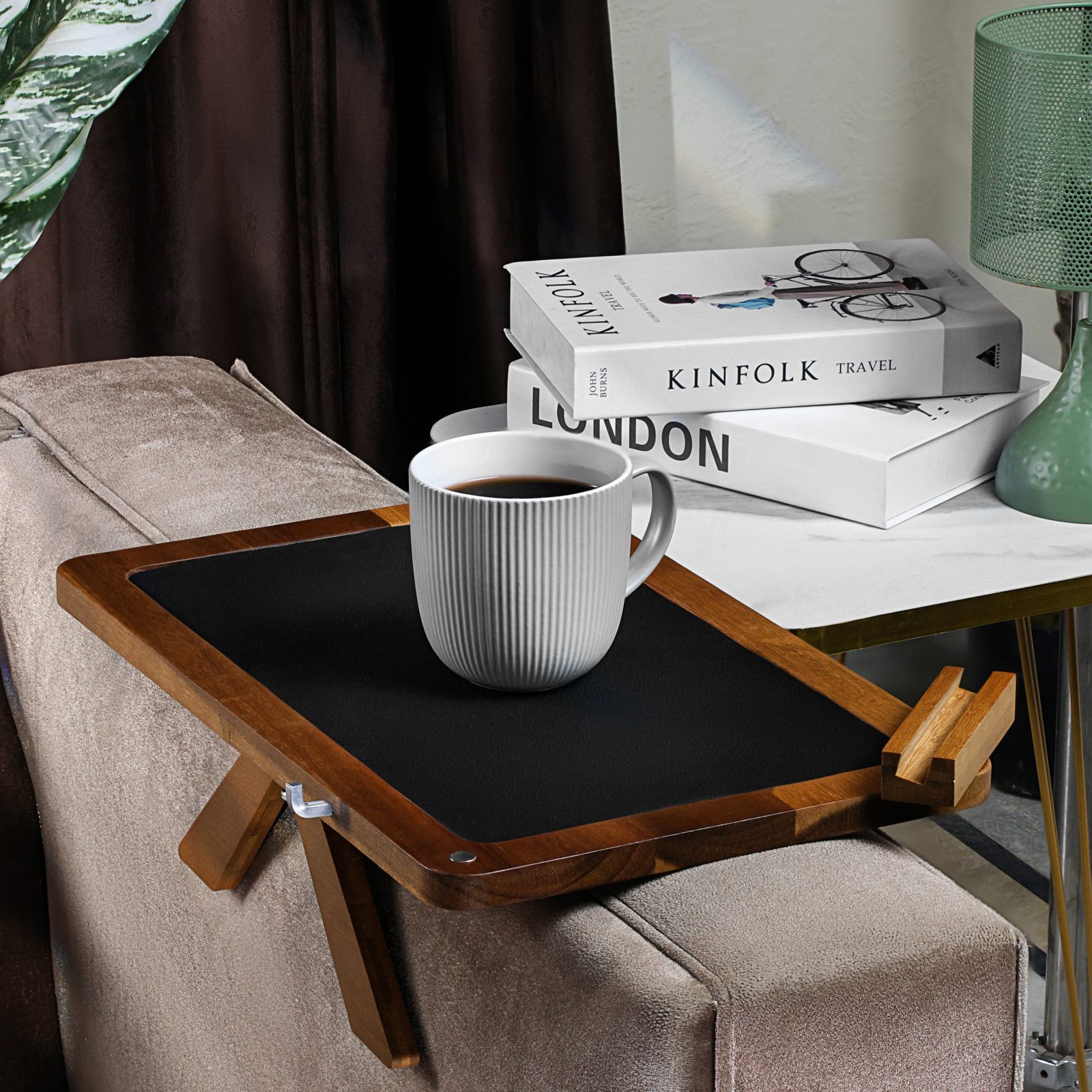 Acacia couch arm tray holding a coffee mug on a sofa armrest